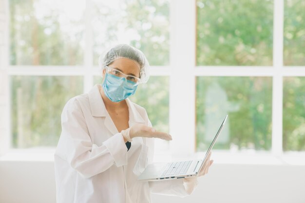 female doctor in a protective mask and medical cap closeup portrait