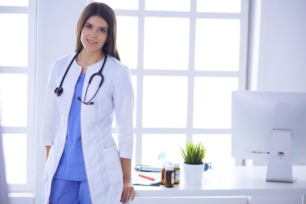 Female doctor standing at hospita with her stethoscope hanging on her neck