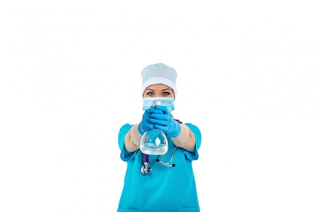 A female doctor in uniform uses a disinfectant spray and holds it in front of her