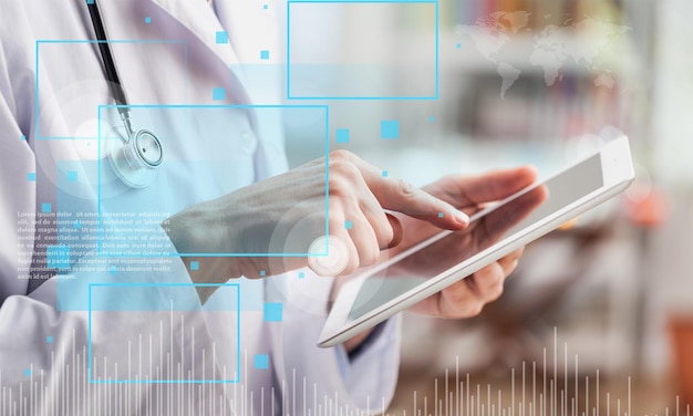 Female doctor using digital tablet, close up on hands