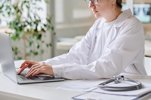 Female doctor using laptop at work