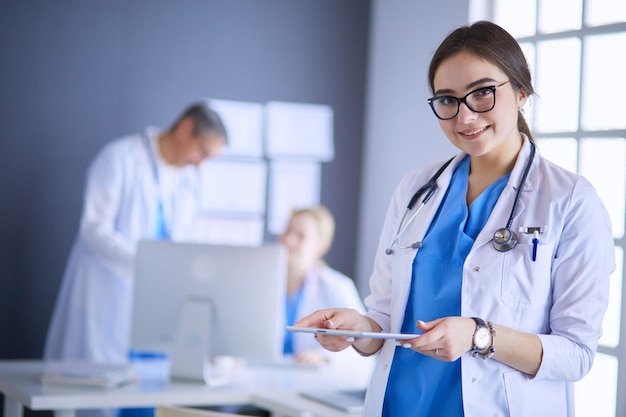 Female doctor using tablet computer in hospital lobby