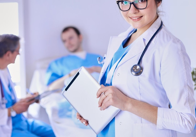 Female doctor using tablet computer in hospital lobby