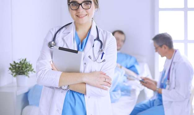 Female doctor using tablet computer in hospital lobby