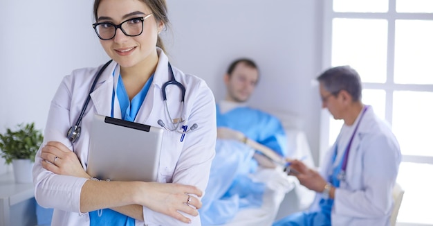 Female doctor using tablet computer in hospital lobby