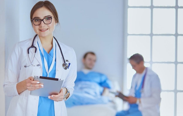 Female doctor using tablet computer in hospital lobby