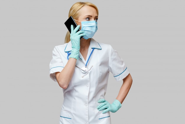 Female doctor wearing protective mask and gloves 