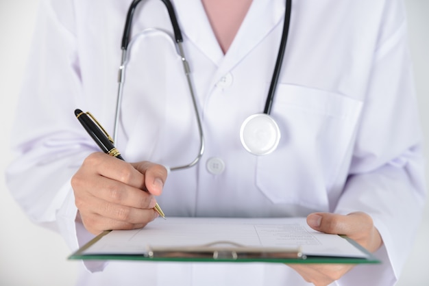 Female doctor with stethoscope holding a clipboard for medical records. Health Check, Medical and health conditions .