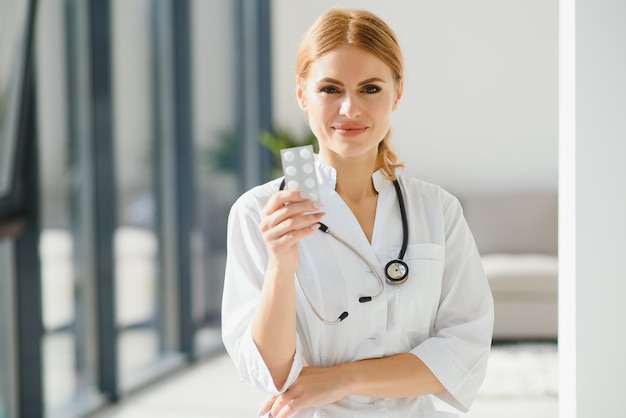 Female doctor with a tablet of pills