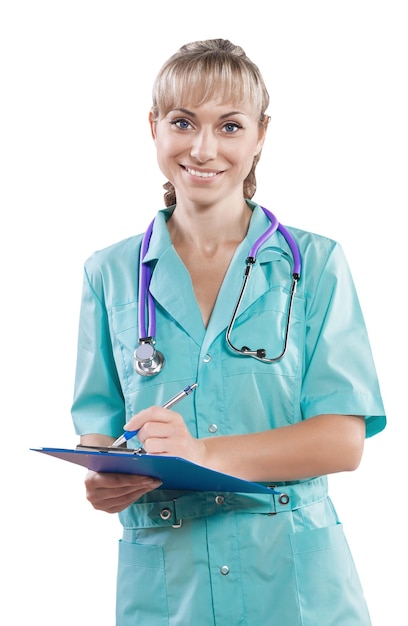 Female doctor writing in clipboard looking at camera smiling isolated