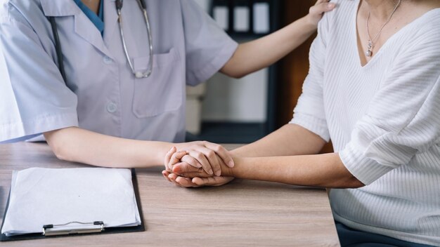 Female doctors shake hands with patients encouraging each other To offer love concern and encouragement while checking the patient's health concept of medicine