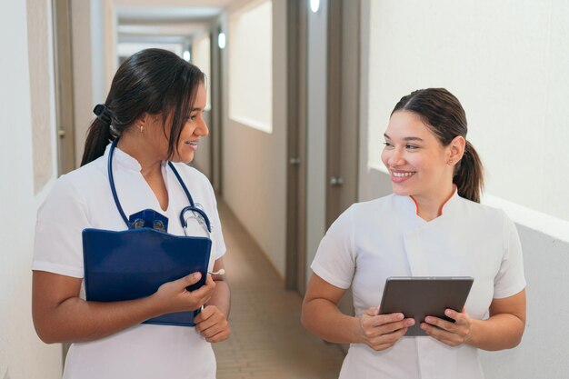 Female doctors talking while walking on hospital