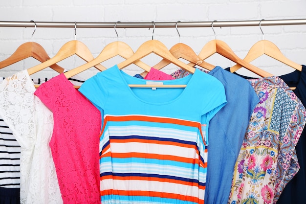 Female dresses on hangers in room