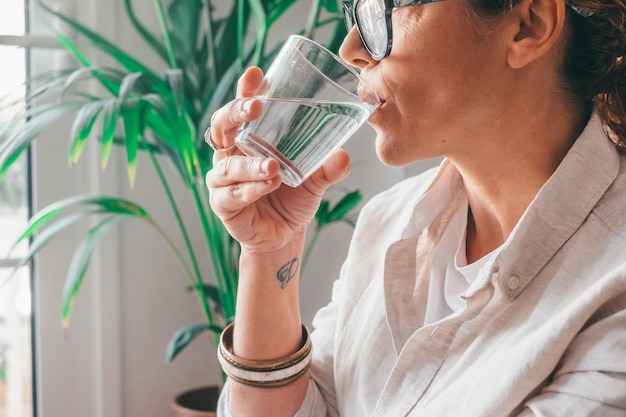 Female drinking from a glass of water Health care concept photo lifestyle close upxA