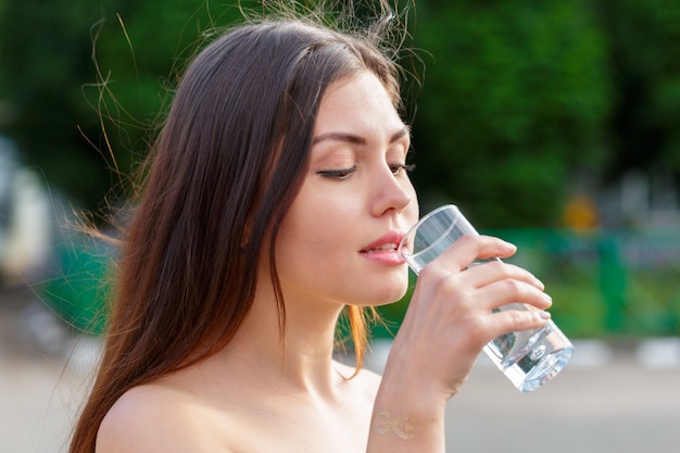 Female drinking from a glass of water. Health care  photo