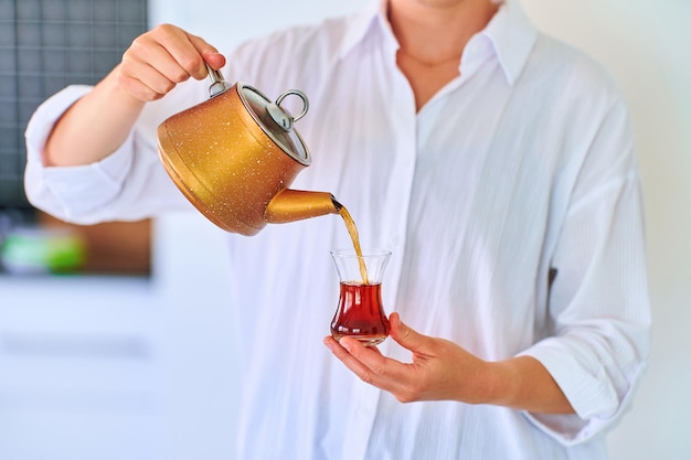 Female drinking traditional turkish tea