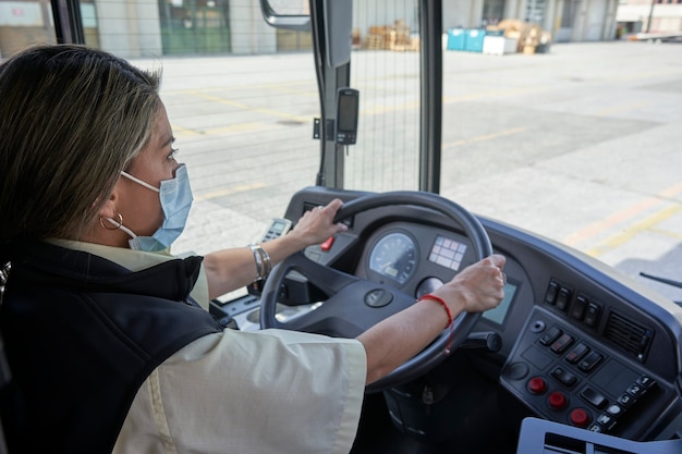 A female driver working in the bus