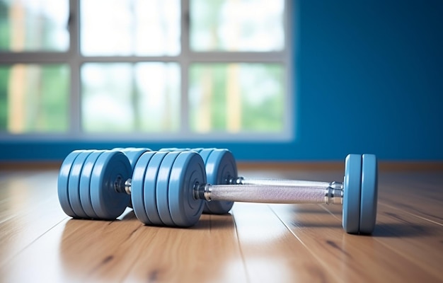 female dumbbells and a skipping rope on a light wooden floor on light sports hall background