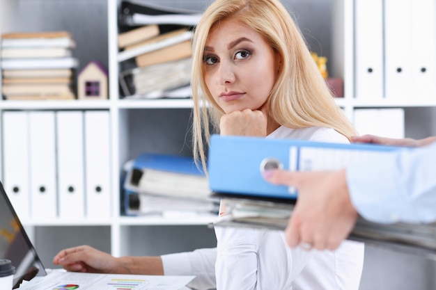 Female employee show pack of documents to manager