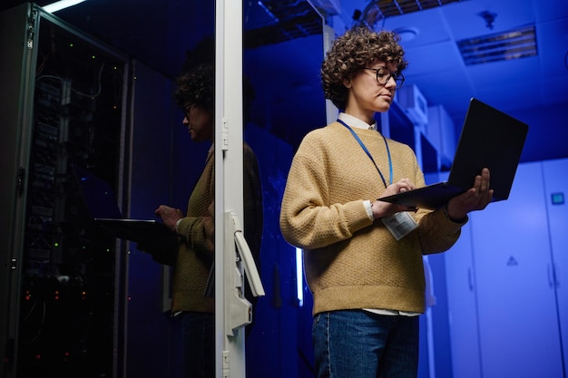 Female engineer examining data on laptop