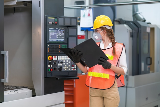 Female engineer operating control CNC Machinery