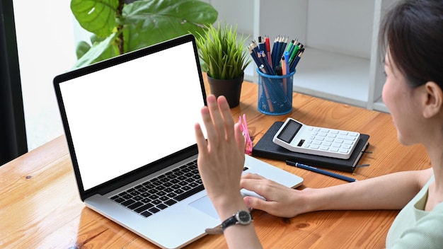 Female entrepreneur having video conference with her business partner on laptop computer