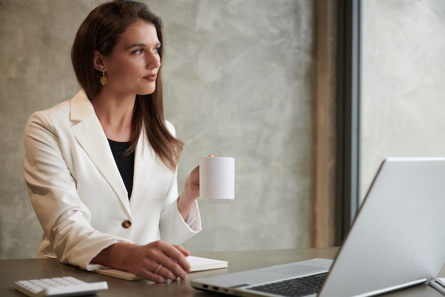 Female Entrepreneur Looking through Window