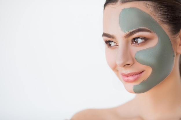 Female face with perfect skin and gray spa mask