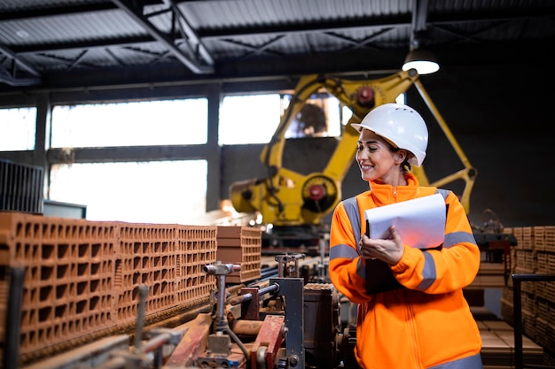 Female factory worker checking quality of the products at production line