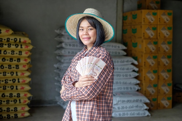 Female farmers pose with banknotes to promote their products