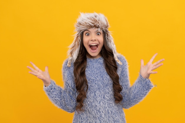 Female fashion model. teen girl in knitwear on yellow background.