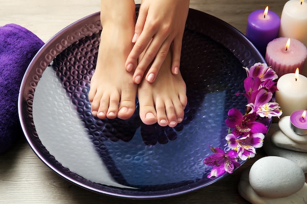 Female feet at spa pedicure procedure