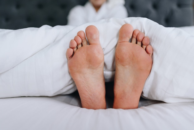 Female feet sticking out of a blanket