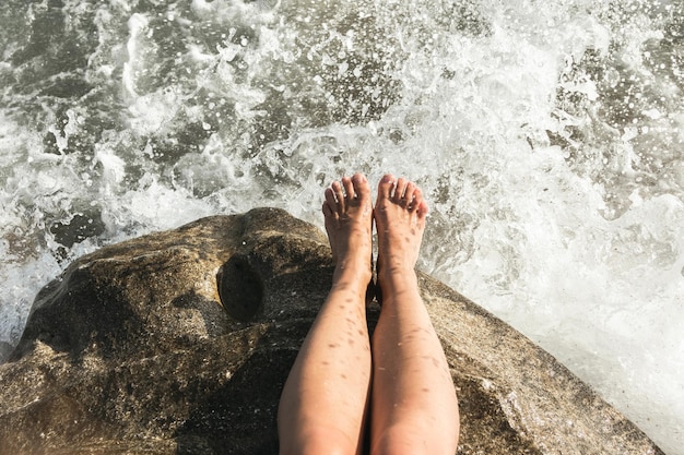 Female feet over stormy sea with first person view