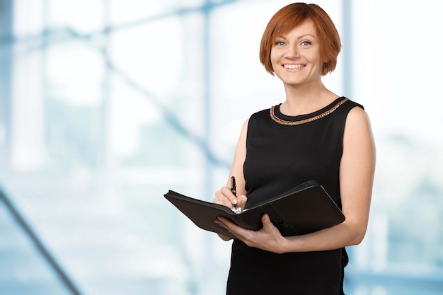 Female finance advisor holding folder on background