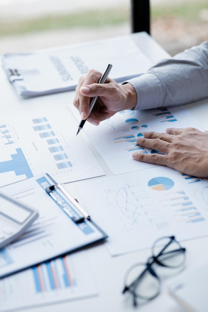 A female financier is reviewing company financial documents monthly financial statement summary from the finance department The concept of managing the company's finances for accuracy and growth