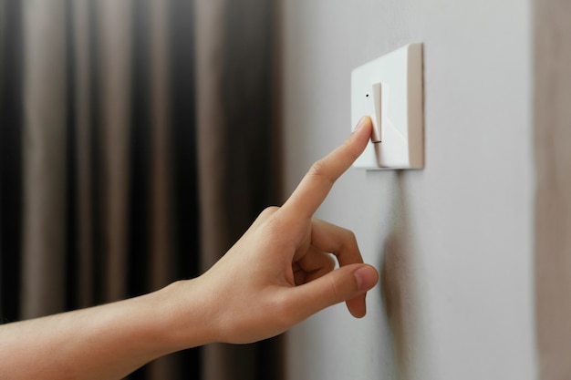 Female finger is turn off on lighting switch