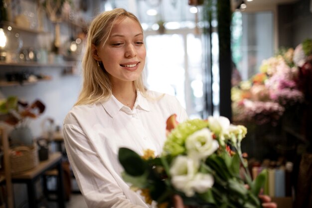 Photo female florist holding a beautiful bouquet