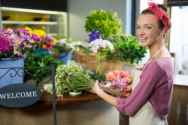 Female florist preparing flower bouquet in flower shop