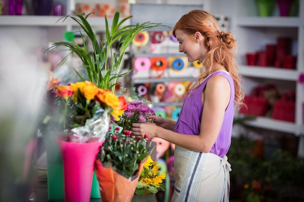 Female florist preparing flower bouquet