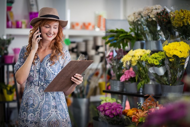 Female florist taking order on mobile phone