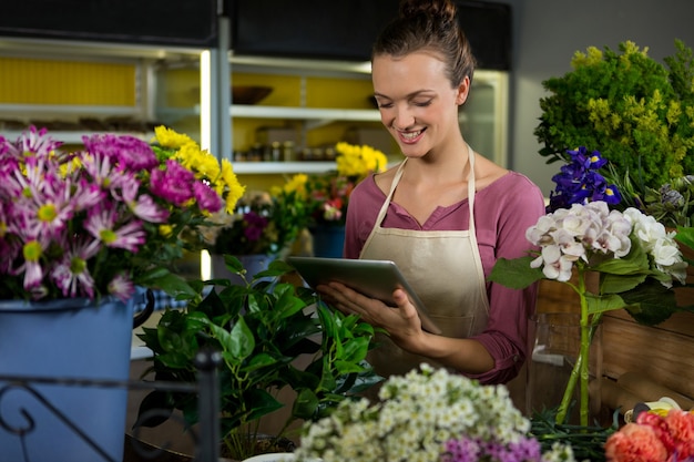 Female florist using digital tablet in florist shop