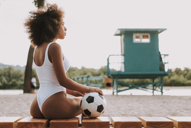 Female Football Player Looking at Sunset on Sea