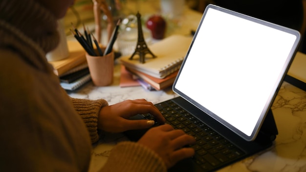 Female freelancer in comfort workspace working typing her project on digital tablet computer