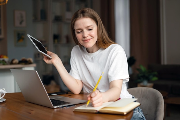 Female freelancer student video communication uses laptop computer at home online training education