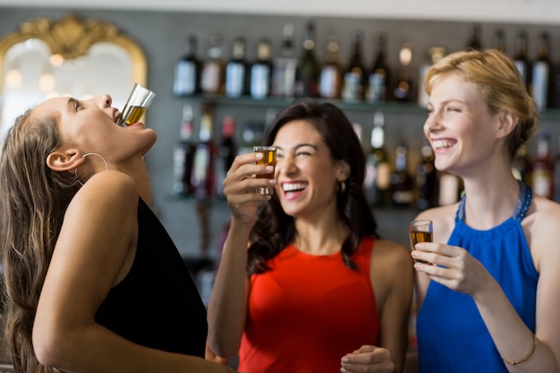 Female friends having tequila shot