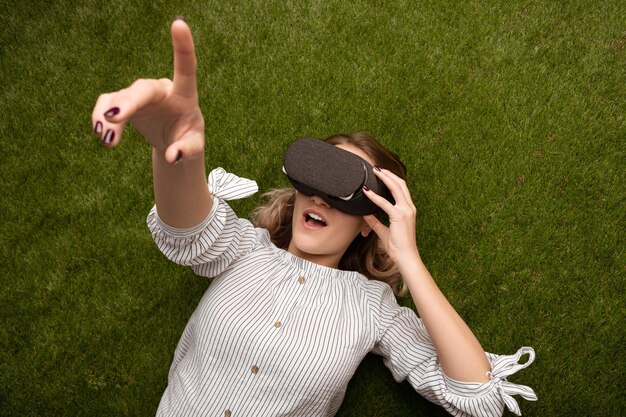 Photo female gamer exploring virtual reality on lawn