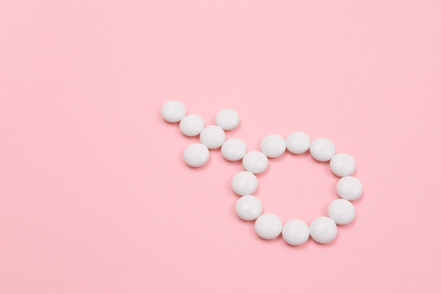 Female gender symbol made from white pills