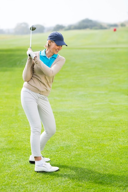 Female golfer taking a shot 