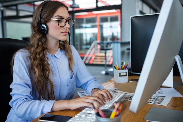 Female graphic designer working over computer at desk